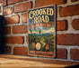 A vintage-style metal sign with the text "Crooked Road Heritage Music Trail Virginia" is displayed on a brick wall.