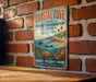 A vintage-style metal sign for Crystal Cove State Marine Conservation Area in California, featuring a coastal landscape with a fish, starfish, and other marine life.