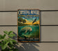 A metal sign with a manatee and palm trees, advertising the Crystal River National Wildlife Refuge in Florida.