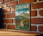 a vintage-style sign for Cuilcag Lakelands Park, Ireland, hanging on a brick wall.