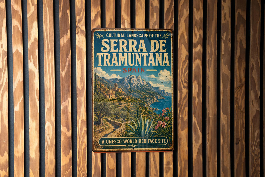 A vintage-style metal sign with the text "CULTURAL LANDSCAPE OF THE SERRA DE TRAMUNTA" and "SPAIN" is displayed on a wooden wall.