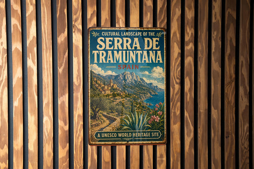 A vintage-style metal sign with the text "CULTURAL LANDSCAPE OF THE SERRA DE TRAMUNTA" and "SPAIN" is displayed on a wooden wall.