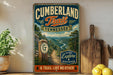 A vintage-style metal sign for the Cumberland Trail in Tennessee, featuring a scenic mountain landscape and a trail marker.