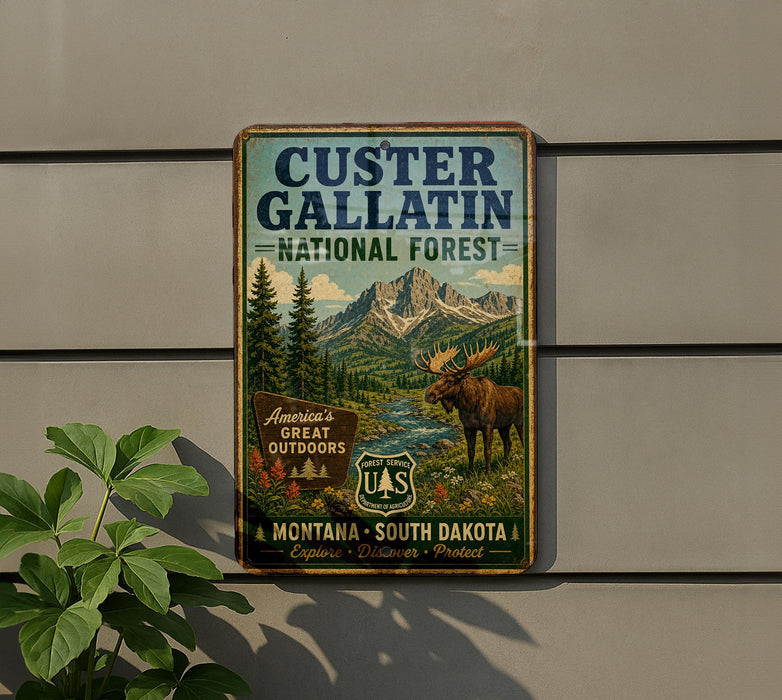 A vintage metal sign for the Custer Gallatin National Forest, featuring a moose and a mountain landscape.