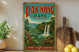 A vintage-style sign for the "Dak Nong Park" in Vietnam, featuring a scenic landscape with a waterfall and lush greenery.