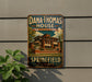 A vintage-style metal sign for Dana Thomas House in Illinois, featuring an illustration of the house and the text "Dana Thomas House Frank Lloyd Wright Masterpiece" and "Springfield Illinois".