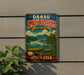 A vintage metal sign with the text "DANAU SENTARUM" and "Keenahanalam Terjunga" is displayed on a wall, with a plant to the left.
