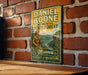 A vintage-style metal sign with the name "DANIEL BOONE" and the title "MEMORIAL STATE FOREST" is displayed on a brick wall.