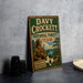 A vintage metal sign for Davy Crockett's National Forest in Texas, featuring an illustration of a man in hunting gear and a deer.