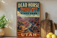 A vintage-style sign for Dead Horse Point State Park in Utah, featuring a scenic illustration of the Grand Canyon.