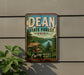 A vintage-style metal sign for the Dean State Forest in Ohio, featuring a scenic landscape with a cliff overlooking a river.