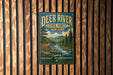 A vintage-style metal sign for the Deer River State Forest in New York, featuring a scenic illustration of a forest and a river.