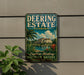 A vintage-style metal sign for Deering Estate, Florida, featuring a tropical landscape with palm trees and a building, is displayed on a wall.