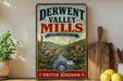 A vintage-style sign for the Derwent Valley Mills, a world heritage site, is displayed on a wooden shelf next to a potted plant and a wooden cutting board.