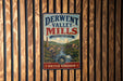 A vintage metal sign for the Derwent Valley Mills, a world heritage site, is displayed on a wooden wall.