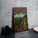 A vintage-style metal sign for Devil's Path in New York, featuring a scenic mountain landscape and directional signs.