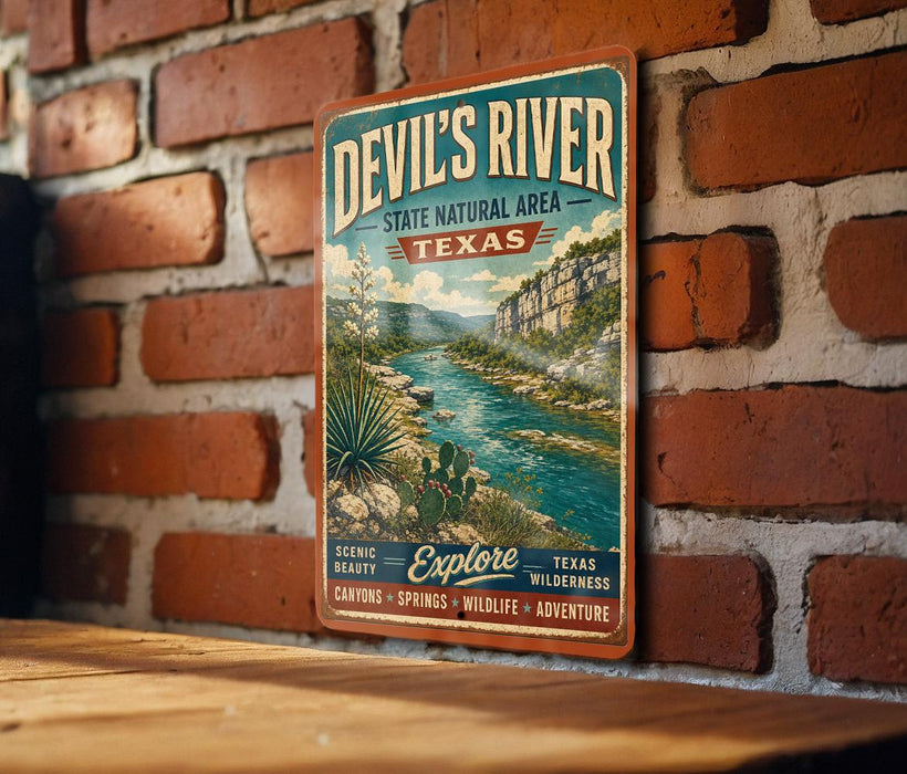 A vintage-style metal sign for Devil's River, a state natural area in Texas, mounted on a brick wall.