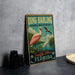 A vintage-style metal sign for the National Wildlife Refuge in Sanibel Island, Florida, featuring a pink flamingo and other birds in a tropical landscape.