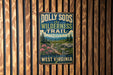 A vintage-style metal sign with the text "Dolly Sods Wilderness Trail" and "West Virginia" is displayed on a wooden wall.