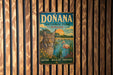 A vintage metal sign for Donana National Park in Spain, featuring an illustration of a cat and a flamingo in a natural setting.