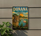 a sign for Donana National Park in Spain, depicting a cat, flamingo, and other wildlife in a scenic landscape.
