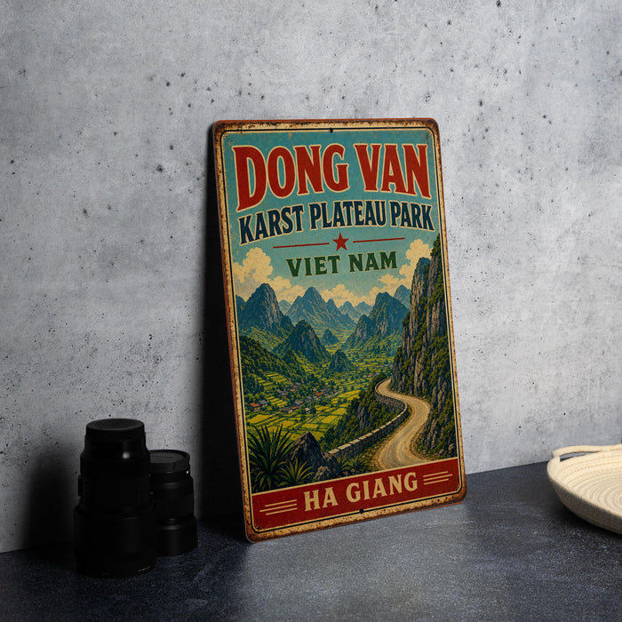 A vintage-style metal sign advertising the Dong Van Karst Plateau Park in Vietnam, featuring a scenic mountain landscape.