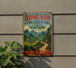A vintage-style metal sign with a scenic mountain landscape and a winding road, mounted on a wall.
