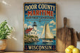 A vintage metal sign for Door County, Wisconsin, featuring a lighthouse and a sailboat on a lake.