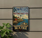 A vintage-style metal sign for Down East Coastal Heritage Landscape, featuring a lighthouse and a coastal scene, mounted on a wall.