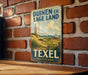 A vintage metal sign with the text "Duinen en Lage Land" and "Texel Nederland" is displayed on a brick wall.