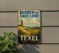 a vintage-style metal sign with a lighthouse and a rural landscape, mounted on a wall.