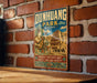 A vintage metal sign for Dunhuang Park in China, featuring an illustration of a temple and a woman, is displayed on a brick wall.
