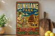 a vintage-style sign for Dunhuang Park, China, with an illustration of a woman playing a stringed instrument and a traditional Chinese temple in the background. The sign is displayed on a wall, surrounded by various kitchen items such as a cutting board, a bowl, and a potted plant.