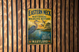 A vintage metal sign for the Eastern Neck National Wildlife Refuge in Maryland, featuring a blue heron and a sunset landscape.