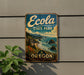 A vintage-style metal sign for Ecola State Park in Oregon, featuring a scenic landscape with mountains, forests, and a coastline.
