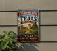 A vintage-style metal sign for the El Camino Real trail in Texas, featuring a scenic illustration of a historic landmark.