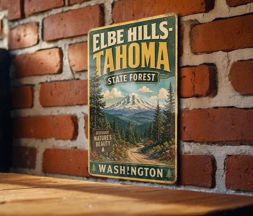 A vintage-style metal sign for Elbe Hills- Tahoma State Forest in Washington, featuring a scenic mountain landscape and a road leading through the forest.