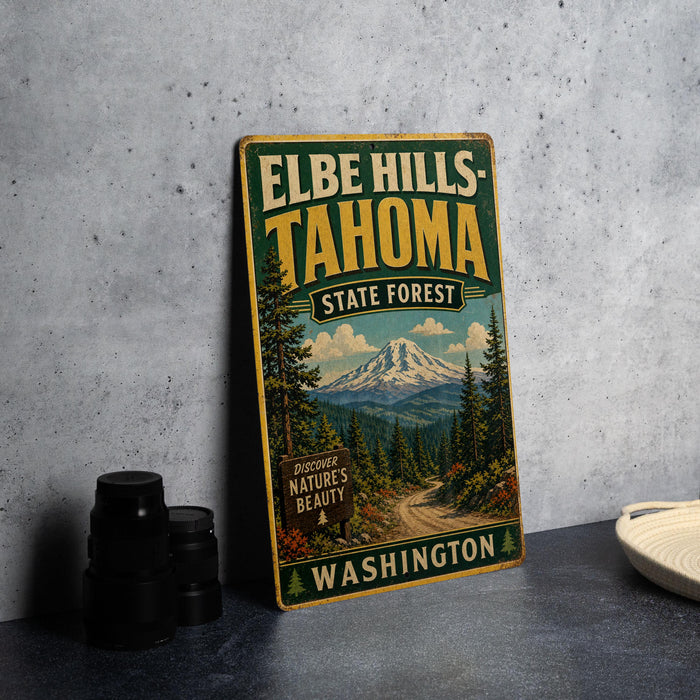 A vintage-style sign for Elbe Hills-Tahoma State Forest in Washington, featuring a mountain landscape and pine trees.