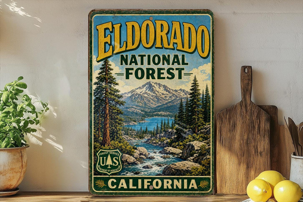 A vintage-style metal sign for Eldorado National Forest in California, featuring a scenic landscape with mountains, pine trees, and a river.