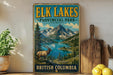 A vintage-style sign for the Elk Lakes Provincial Park in British Columbia, featuring a scenic mountain landscape with a moose and a lake.