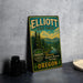 A vintage metal sign for Elliott State Forest, featuring a scenic landscape with pine trees and mountains, is displayed on a gray concrete surface.