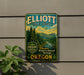 A metal sign for Elliott State Forest, featuring a scenic illustration of a forest landscape with mountains in the background.