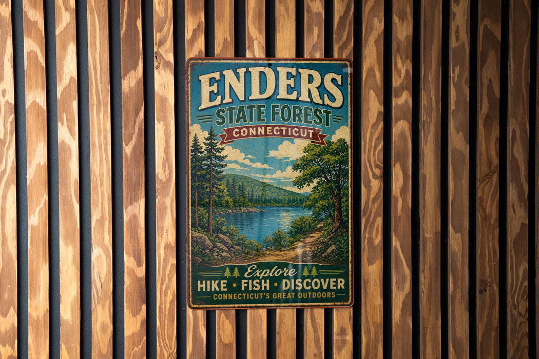 A vintage metal sign for Enders State Forest in Connecticut, featuring a scenic landscape with a lake, mountains, and pine trees.