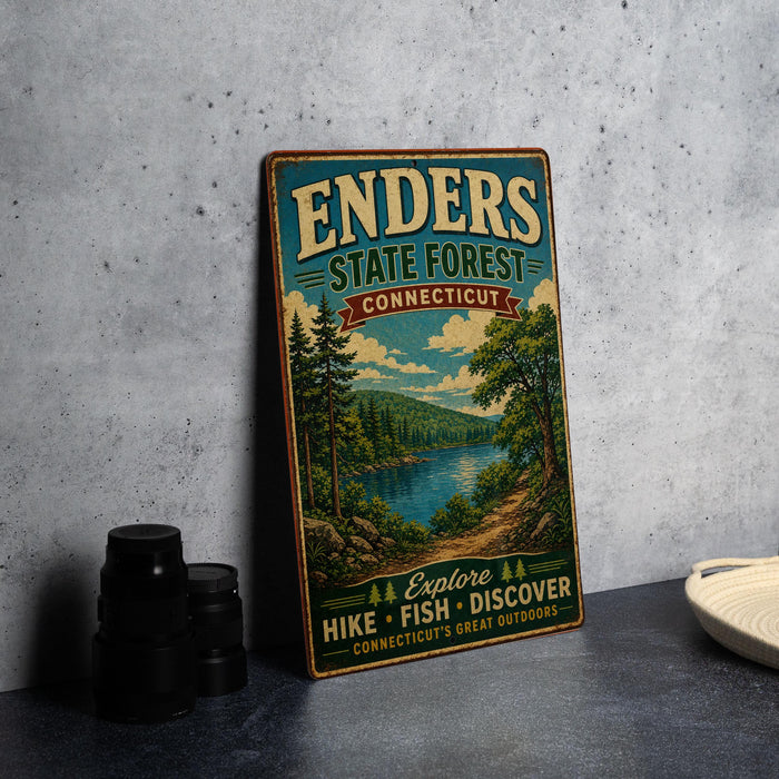 A vintage-style metal sign for the Enders State Forest in Connecticut, featuring a scenic landscape with a lake and forest.