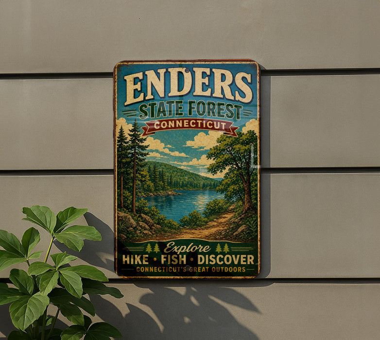 A vintage metal sign for Enders State Forest in Connecticut, featuring a scenic landscape with pine trees, a lake, and mountains.