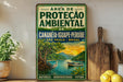 a vintage-style sign with a tropical scene, including a boat, a bird, and a lush landscape, displayed on a shelf next to a wooden cutting board and some lemons.