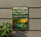 a vintage-style sign with a tropical scene, including a boat, palm trees, and a bird, mounted on a wall.