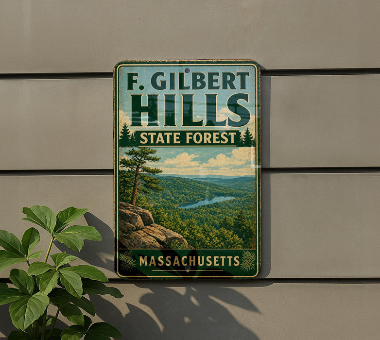A vintage metal sign for F. Gilbert Hills State Forest in Massachusetts, featuring a scenic landscape with a mountain, lake, and pine trees.