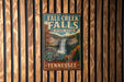 A vintage-style metal sign for Fall Creek Falls State Park in Tennessee, featuring a waterfall and autumn foliage.