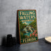 A vintage-style sign for Falling Waters State Park in Florida, featuring a waterfall and lush greenery.